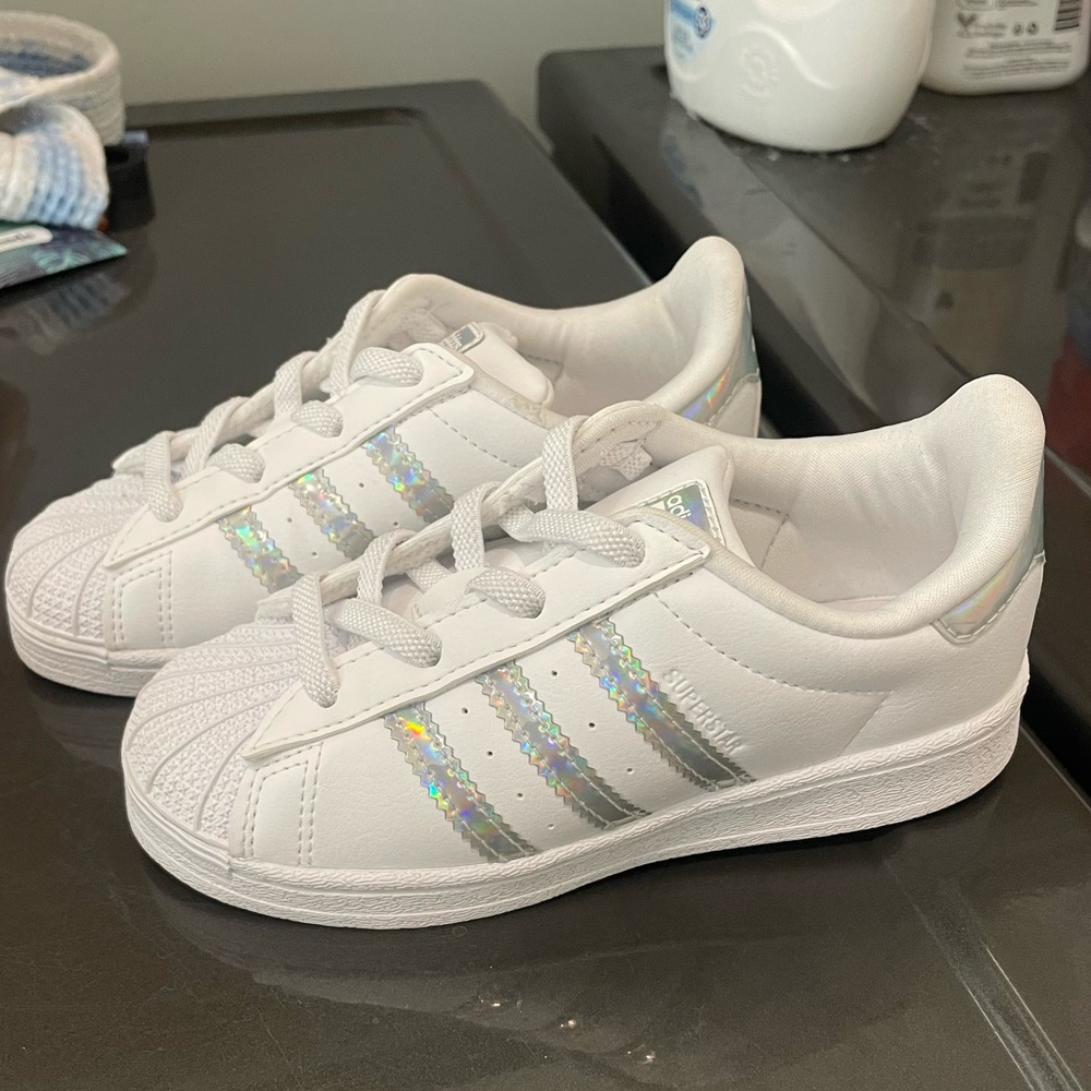 Adidas Superstar Sneaker. White with silver stripes. Size 9. Never worn!!